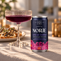 Lots of Purple can with a glass of purple sparkling drink and mushroom crostini.